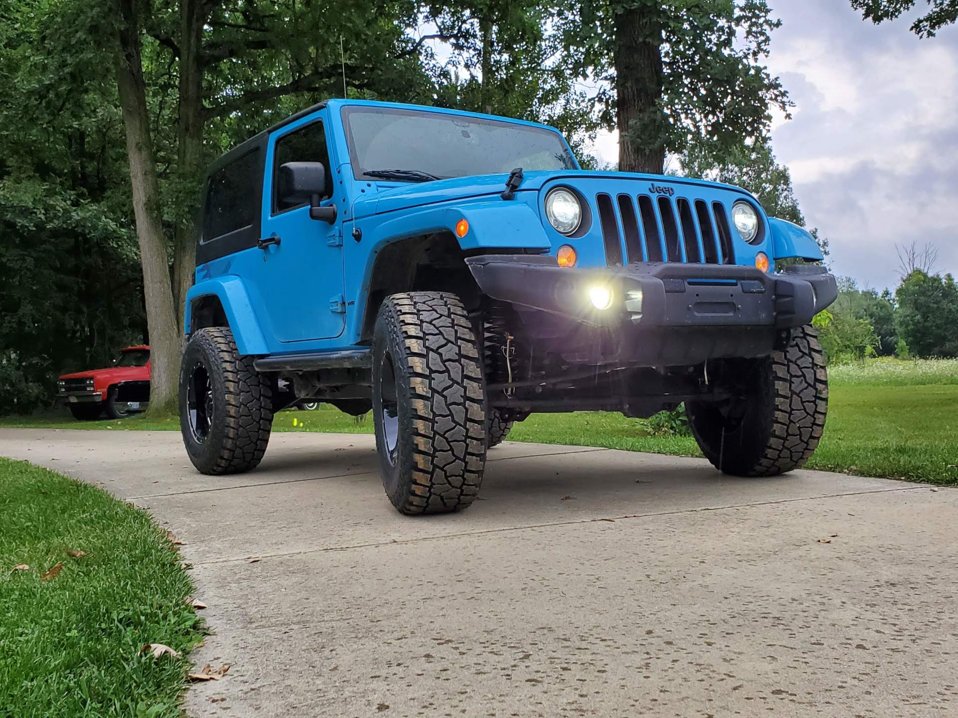 Front of the 2014 Jeep Wrangler on a driveway